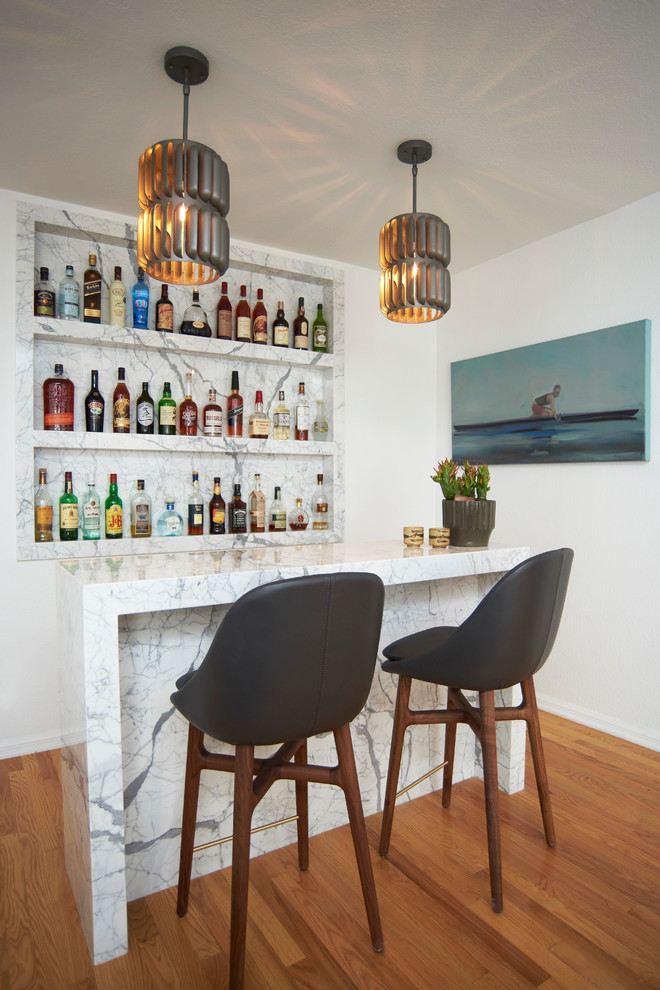 Design ideas for a medium sized coastal single-wall wet bar in Los Angeles with open cabinets, marble worktops, marble splashback and light hardwood flooring.