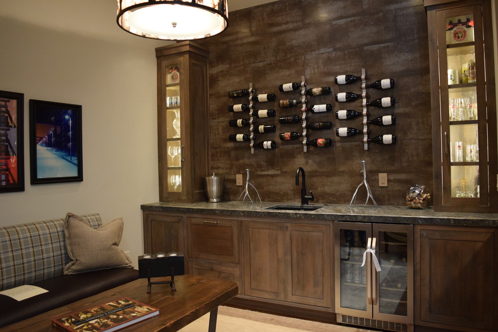 Large single-wall carpeted wet bar photo in Other with an undermount sink, flat-panel cabinets, dark wood cabinets, granite countertops, brown backsplash and porcelain backsplash