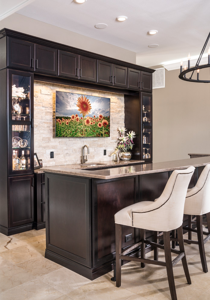 Traditional single-wall breakfast bar in Tampa with a submerged sink, shaker cabinets, dark wood cabinets, beige splashback, stone tiled splashback and beige floors.