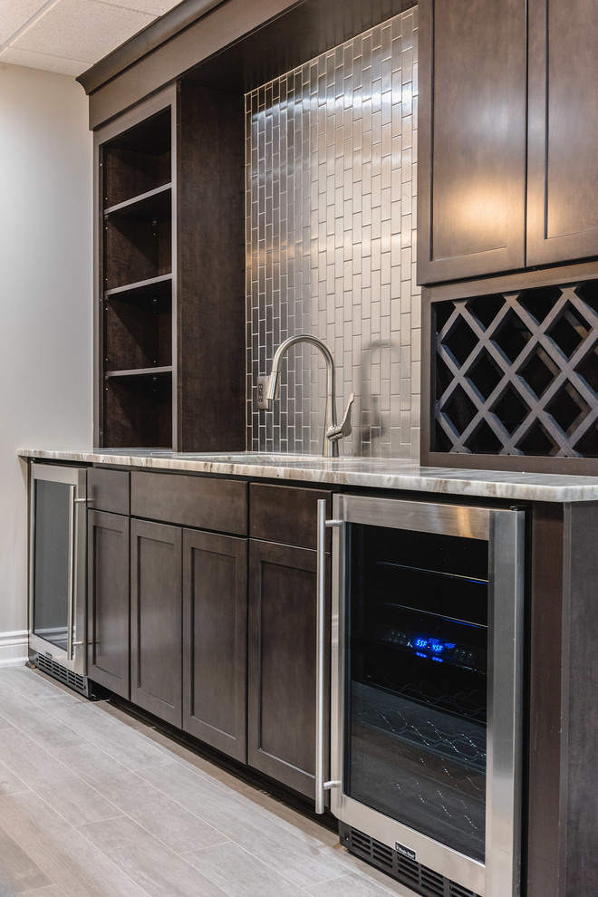 Photo of a medium sized contemporary single-wall wet bar in Detroit with a submerged sink, shaker cabinets, dark wood cabinets, granite worktops, metro tiled splashback, porcelain flooring and beige floors.