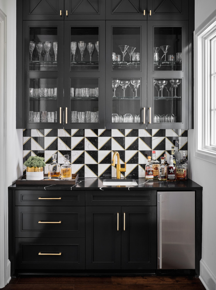 Photo of a classic home bar with a submerged sink, recessed-panel cabinets, black cabinets, ceramic splashback, dark hardwood flooring and black worktops.