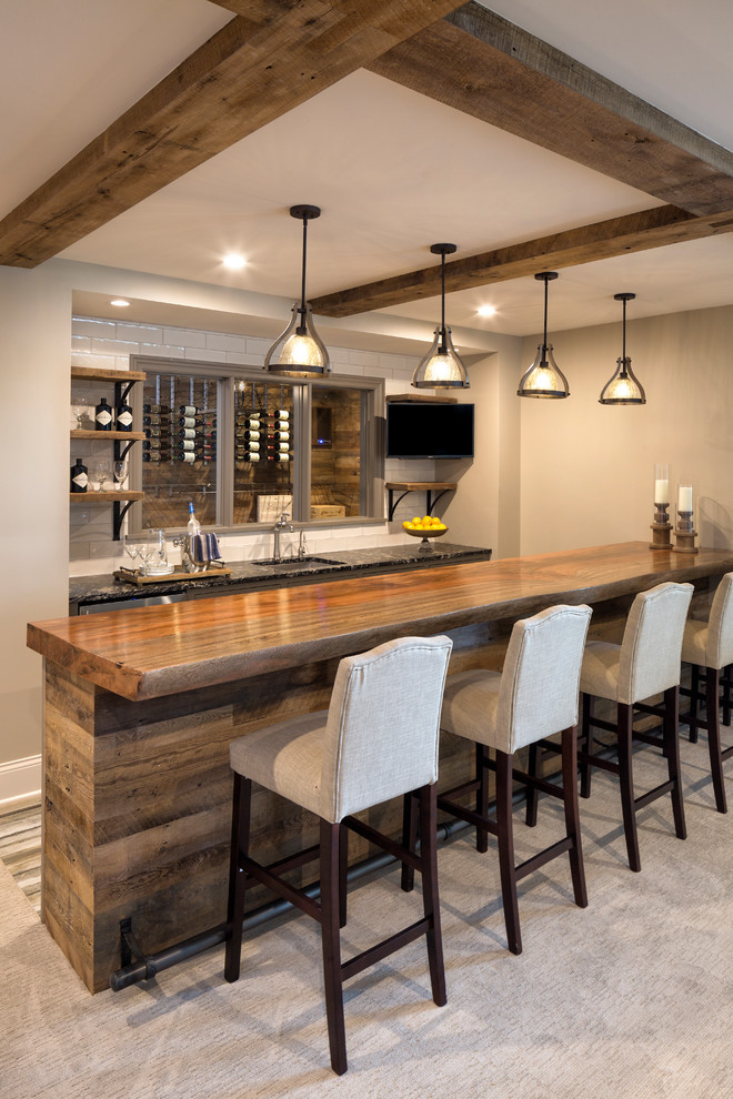 Inspiration for a classic wet bar in Minneapolis with a submerged sink, wood worktops, white splashback, metro tiled splashback, carpet, grey floors and brown worktops.