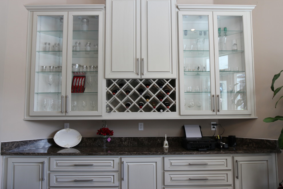 Inspiration for a medium sized classic single-wall wet bar in Jacksonville with no sink, raised-panel cabinets, white cabinets, quartz worktops, dark hardwood flooring, brown floors and black worktops.