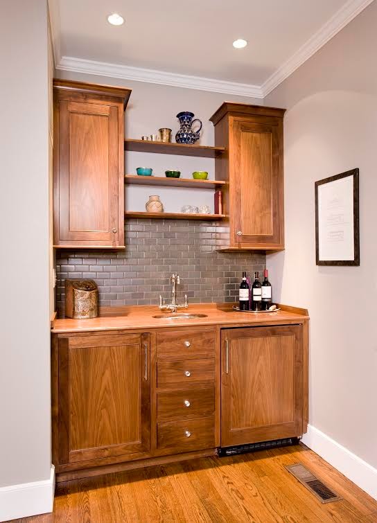 Inspiration for a small transitional single-wall medium tone wood floor wet bar remodel in Boston with an undermount sink, recessed-panel cabinets and medium tone wood cabinets
