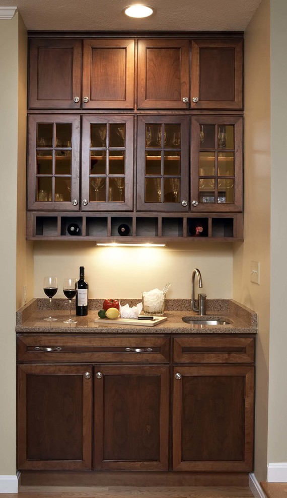 Example of a transitional u-shaped light wood floor wet bar design in Boston with recessed-panel cabinets, medium tone wood cabinets and granite countertops