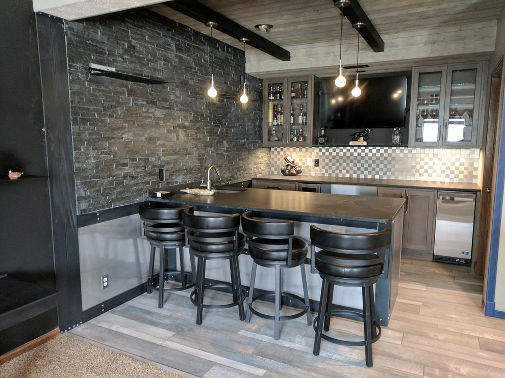 Mid-sized urban light wood floor and gray floor wet bar photo in Omaha with an undermount sink, shaker cabinets, gray cabinets, granite countertops, gray backsplash and metal backsplash