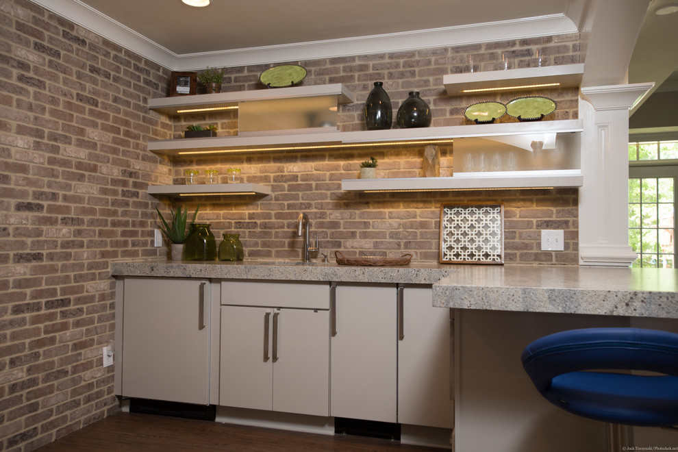 This is an example of a large traditional l-shaped breakfast bar in Atlanta with flat-panel cabinets, white cabinets, granite worktops, beige splashback and carpet.