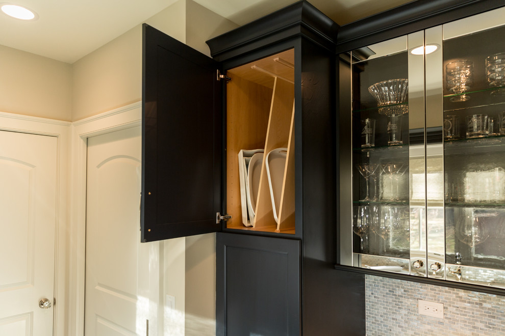 Example of a small classic galley medium tone wood floor home bar design in Milwaukee with blue backsplash, mosaic tile backsplash, recessed-panel cabinets, dark wood cabinets and quartz countertops