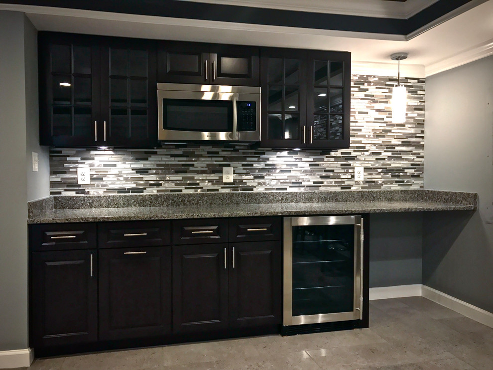 Example of a mid-sized trendy single-wall carpeted and gray floor seated home bar design in DC Metro with no sink, raised-panel cabinets, black cabinets, recycled glass countertops, gray backsplash and matchstick tile backsplash