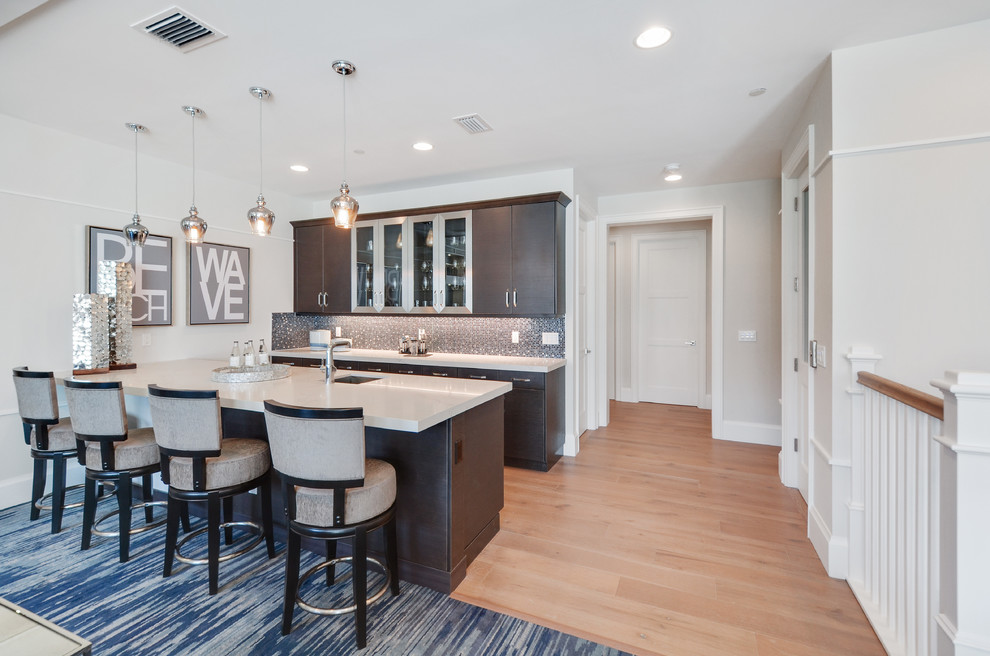 Example of a large trendy galley light wood floor and beige floor seated home bar design in Miami with an undermount sink, flat-panel cabinets, dark wood cabinets, brown backsplash and glass tile backsplash