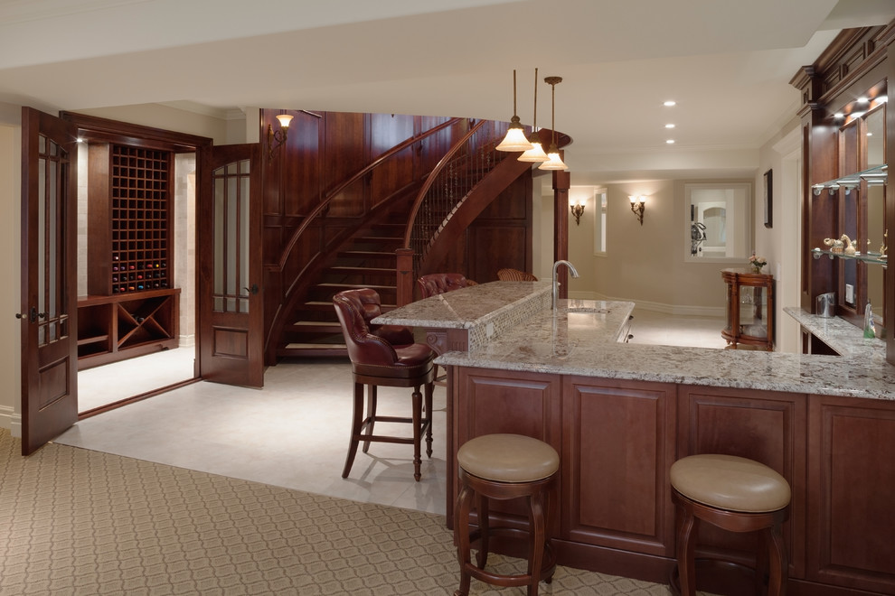 This is an example of an expansive traditional u-shaped wet bar in Calgary with a submerged sink, open cabinets, dark wood cabinets, granite worktops, brown splashback, mosaic tiled splashback and porcelain flooring.