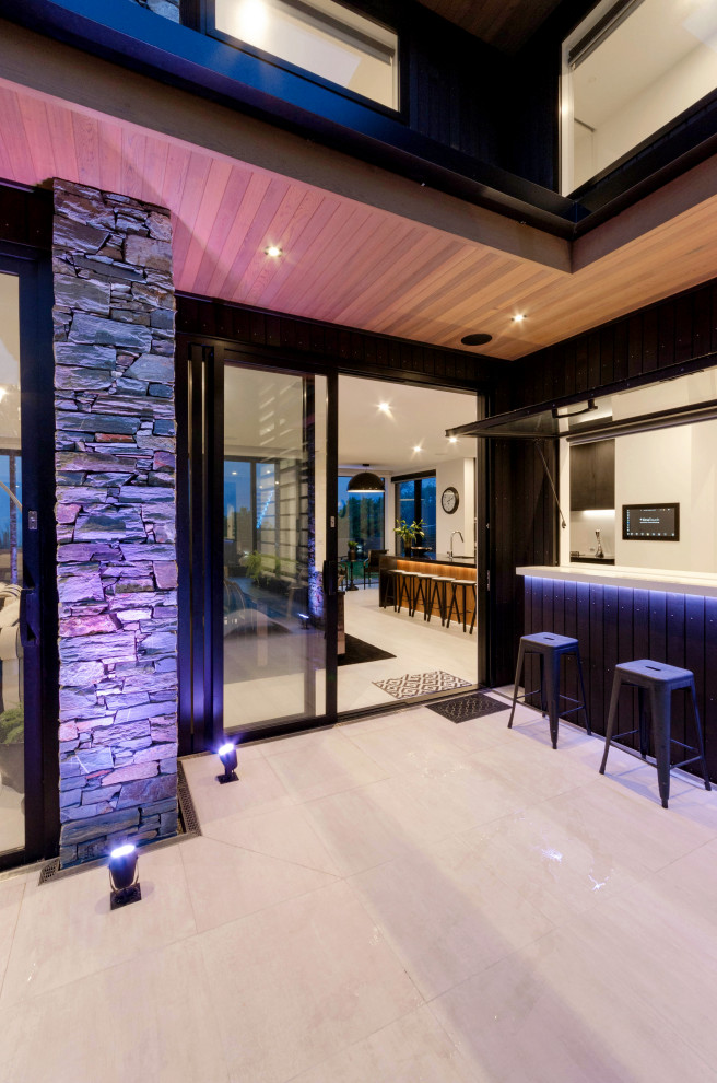 This is an example of a large contemporary single-wall wet bar in Auckland with recessed-panel cabinets, white cabinets, engineered stone countertops, ceramic flooring, white floors and white worktops.