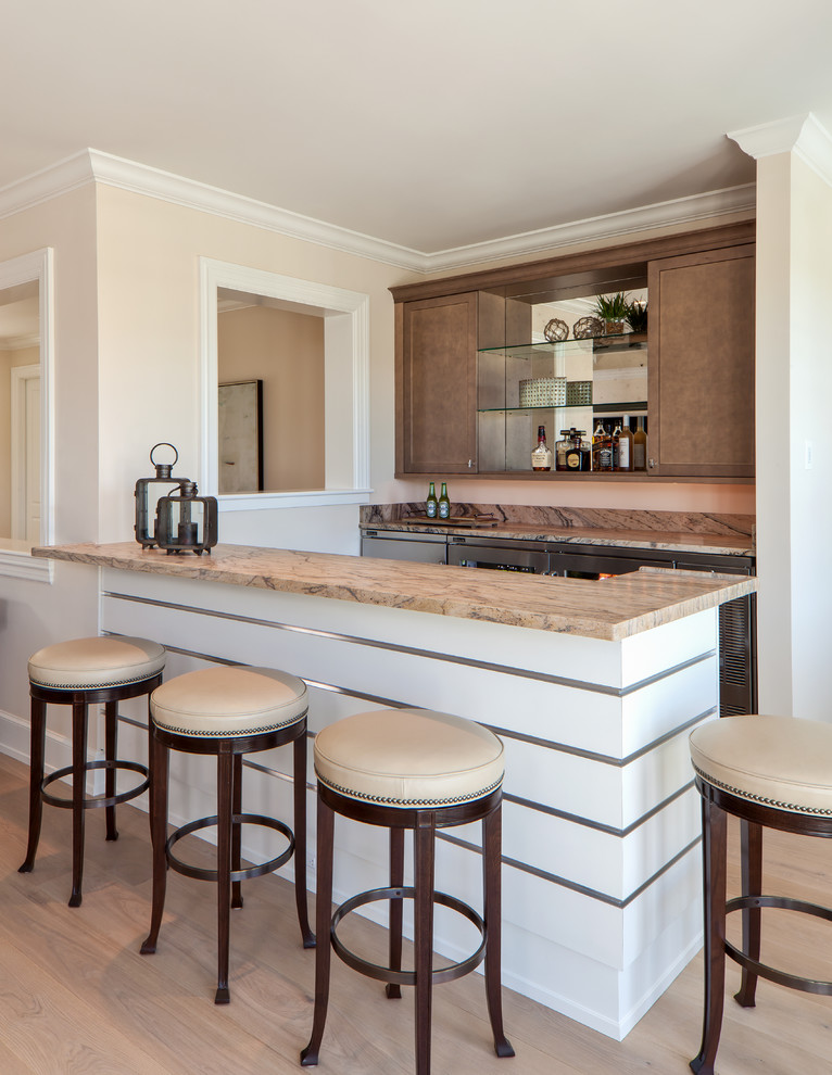 This is an example of a coastal galley home bar in Miami with shaker cabinets, medium wood cabinets and light hardwood flooring.
