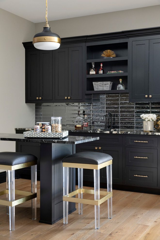 Seated home bar - mid-sized coastal beige floor and light wood floor seated home bar idea in Minneapolis with an undermount sink, black cabinets, granite countertops, black backsplash, glass tile backsplash, multicolored countertops and shaker cabinets