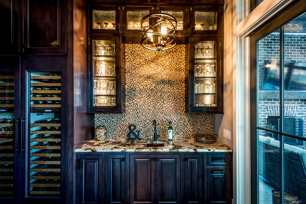 Inspiration for a mid-sized transitional galley brown floor and medium tone wood floor wet bar remodel in Charleston with an undermount sink, raised-panel cabinets, dark wood cabinets, granite countertops, brown backsplash and mosaic tile backsplash