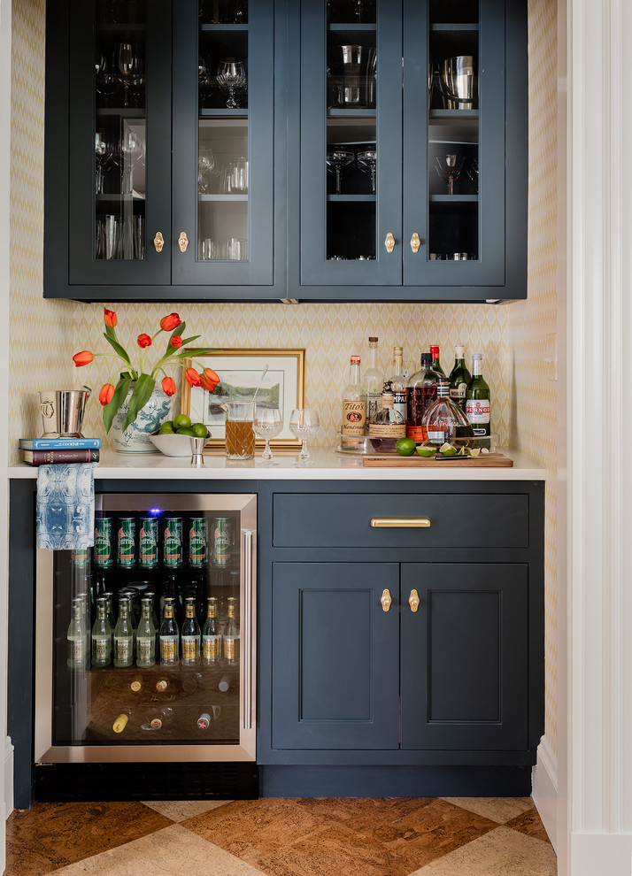 Inspiration for a traditional single-wall home bar in Boston with no sink, glass-front cabinets, blue cabinets, multi-coloured floors and white worktops.
