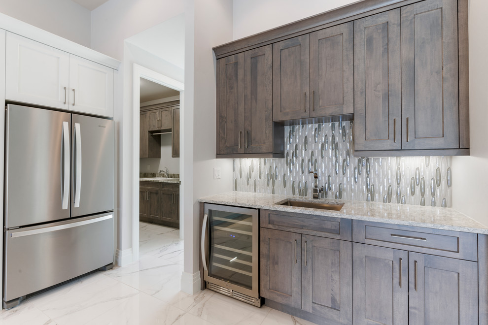 Example of a mid-sized trendy single-wall porcelain tile wet bar design in Other with a drop-in sink, recessed-panel cabinets, dark wood cabinets, quartz countertops, multicolored backsplash and multicolored countertops