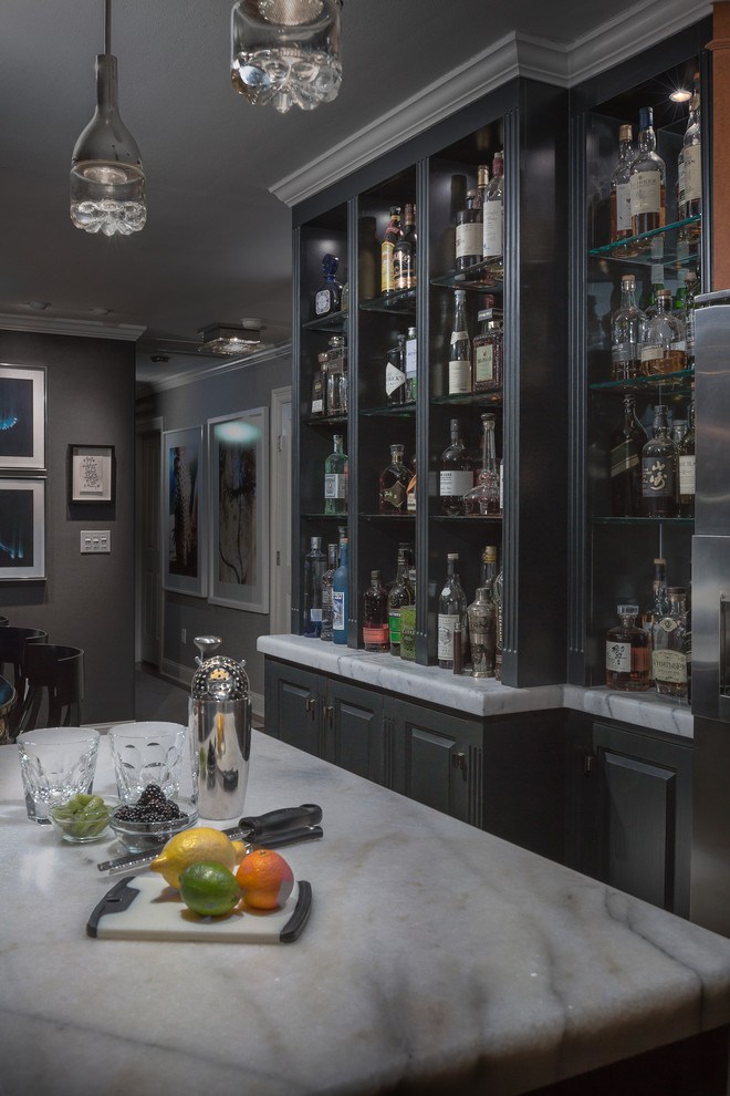 Inspiration for a small contemporary single-wall home bar in New York with a submerged sink, raised-panel cabinets, black cabinets, marble worktops, white splashback, ceramic splashback and porcelain flooring.