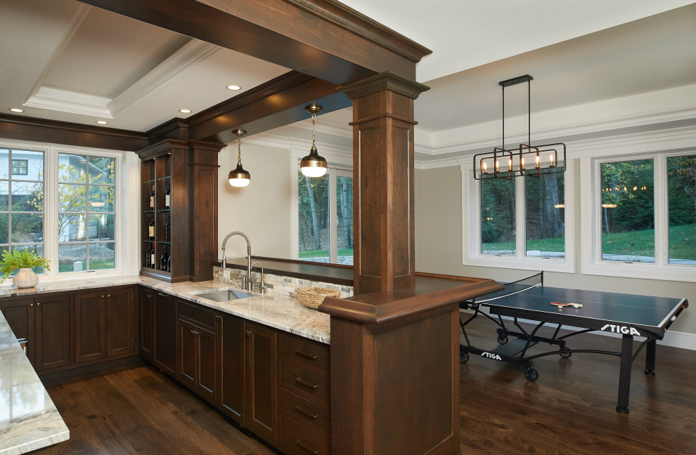 Example of a mid-sized classic u-shaped dark wood floor and brown floor wet bar design in Grand Rapids with an undermount sink, flat-panel cabinets, dark wood cabinets, quartz countertops, beige backsplash, stone tile backsplash and beige countertops
