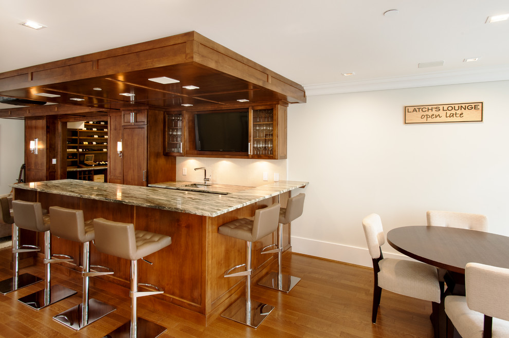 Example of a large arts and crafts u-shaped medium tone wood floor seated home bar design in Vancouver with recessed-panel cabinets, medium tone wood cabinets, quartzite countertops, white backsplash and ceramic backsplash