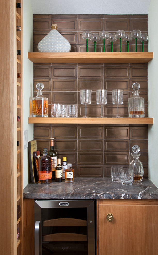 Inspiration for a small contemporary home bar in Austin with no sink, flat-panel cabinets, light wood cabinets, marble worktops and light hardwood flooring.