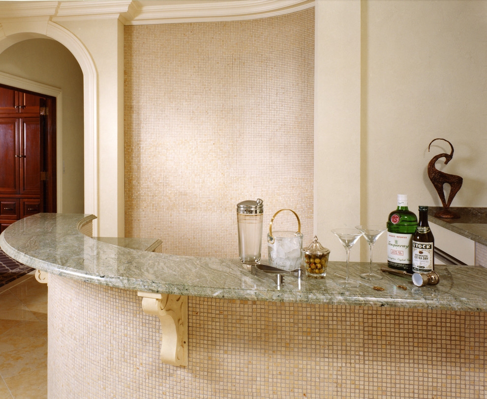 Seated home bar - traditional l-shaped seated home bar idea in New York with granite countertops and beige backsplash