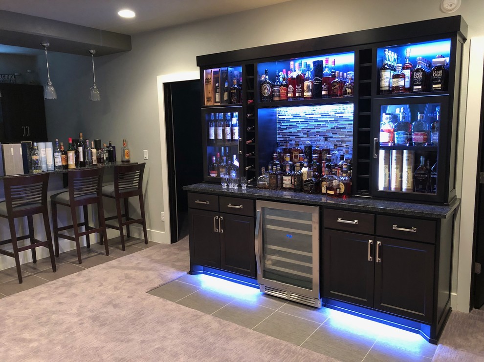Medium sized classic single-wall home bar in Other with no sink, dark wood cabinets, granite worktops, multi-coloured splashback, glass sheet splashback, vinyl flooring, multi-coloured floors and multicoloured worktops.
