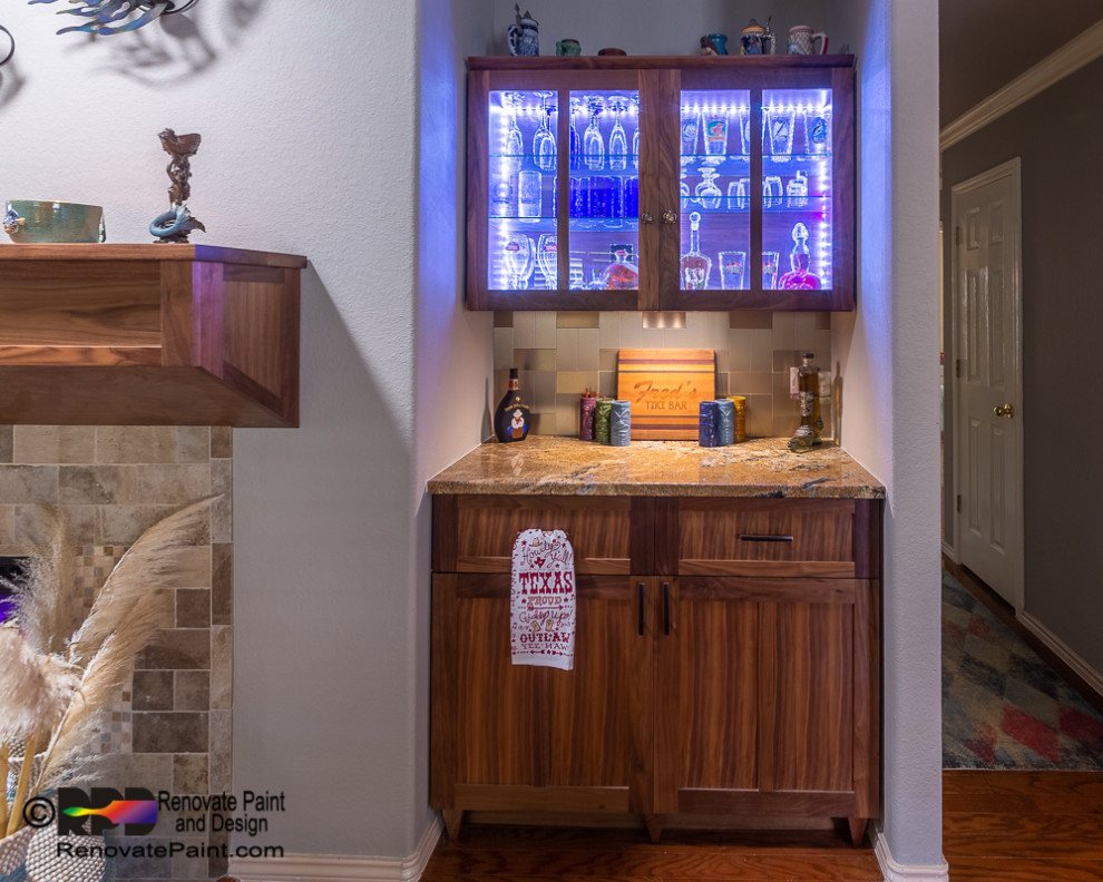 This is an example of a small contemporary single-wall home bar in Austin with glass-front cabinets, medium wood cabinets, granite worktops, white splashback, ceramic splashback, medium hardwood flooring, brown floors and beige worktops.