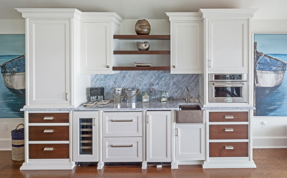 Photo of a medium sized contemporary single-wall breakfast bar in New York with a submerged sink, raised-panel cabinets, white cabinets, marble worktops, grey splashback, marble splashback, laminate floors, brown floors and grey worktops.