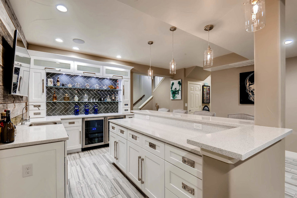 Example of a small trendy u-shaped ceramic tile and gray floor wet bar design in Denver with an undermount sink, shaker cabinets, white cabinets, quartz countertops, brown backsplash, wood backsplash and white countertops