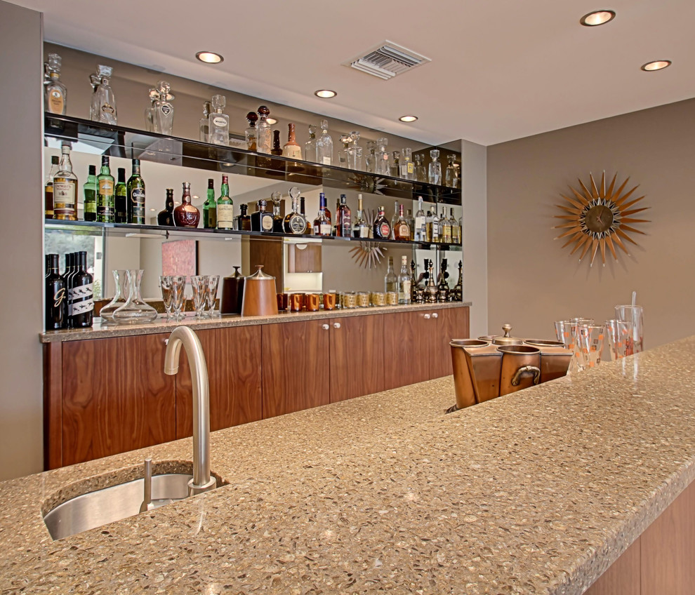 This is an example of a midcentury home bar in Other.