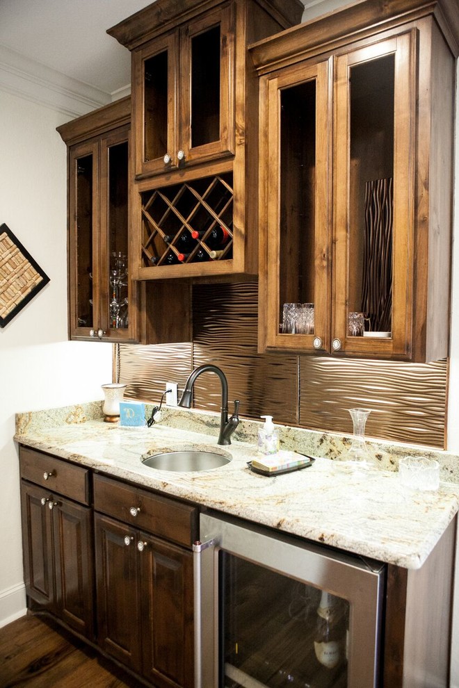 Example of a small classic single-wall dark wood floor wet bar design in Austin with an undermount sink, raised-panel cabinets, dark wood cabinets, granite countertops and brown backsplash