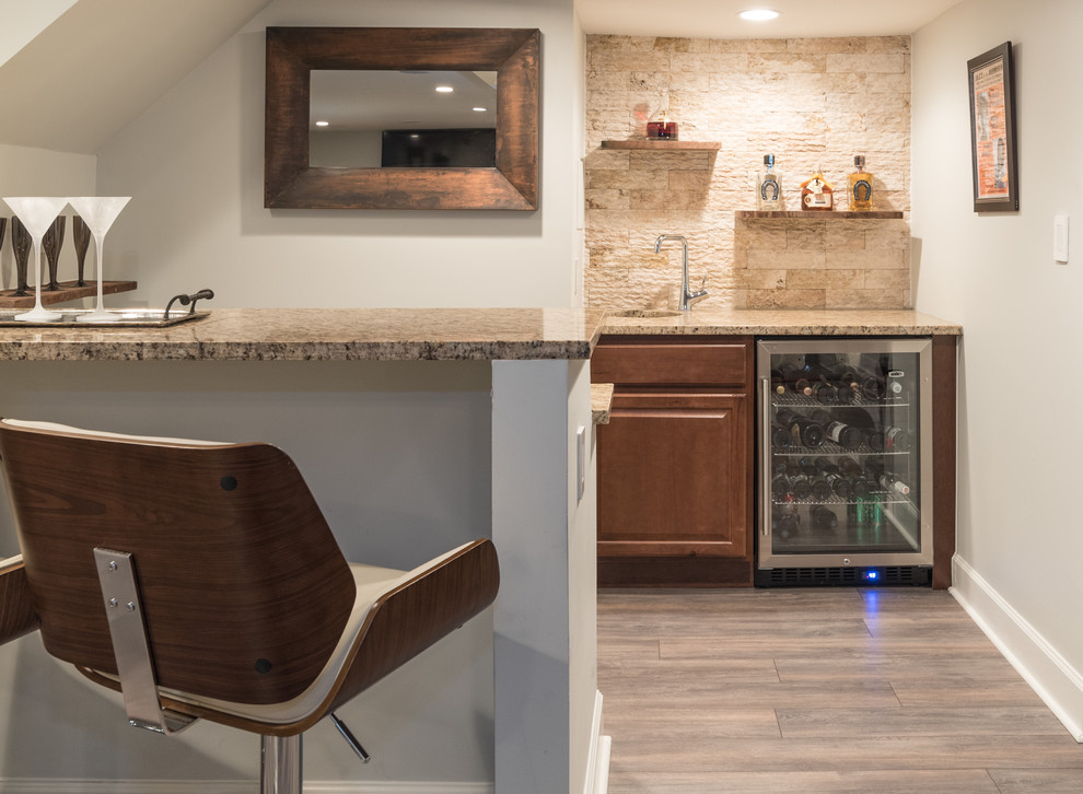 Design ideas for a small contemporary u-shaped breakfast bar in DC Metro with a submerged sink, raised-panel cabinets, medium wood cabinets, granite worktops, beige splashback, stone tiled splashback, laminate floors and beige floors.