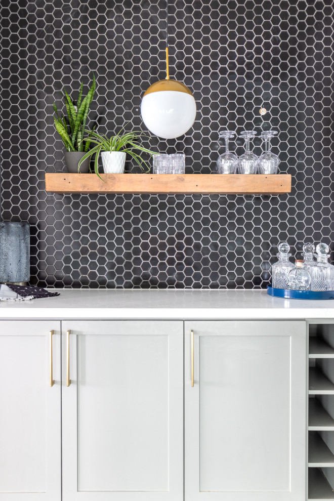 This is an example of a small modern single-wall dry bar in Toronto with shaker cabinets, grey cabinets, wood worktops, black splashback, porcelain splashback, medium hardwood flooring, brown floors and white worktops.