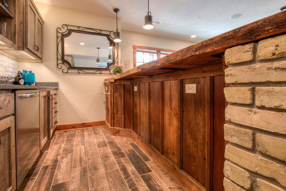 This is an example of a rustic wet bar in Milwaukee with porcelain flooring.