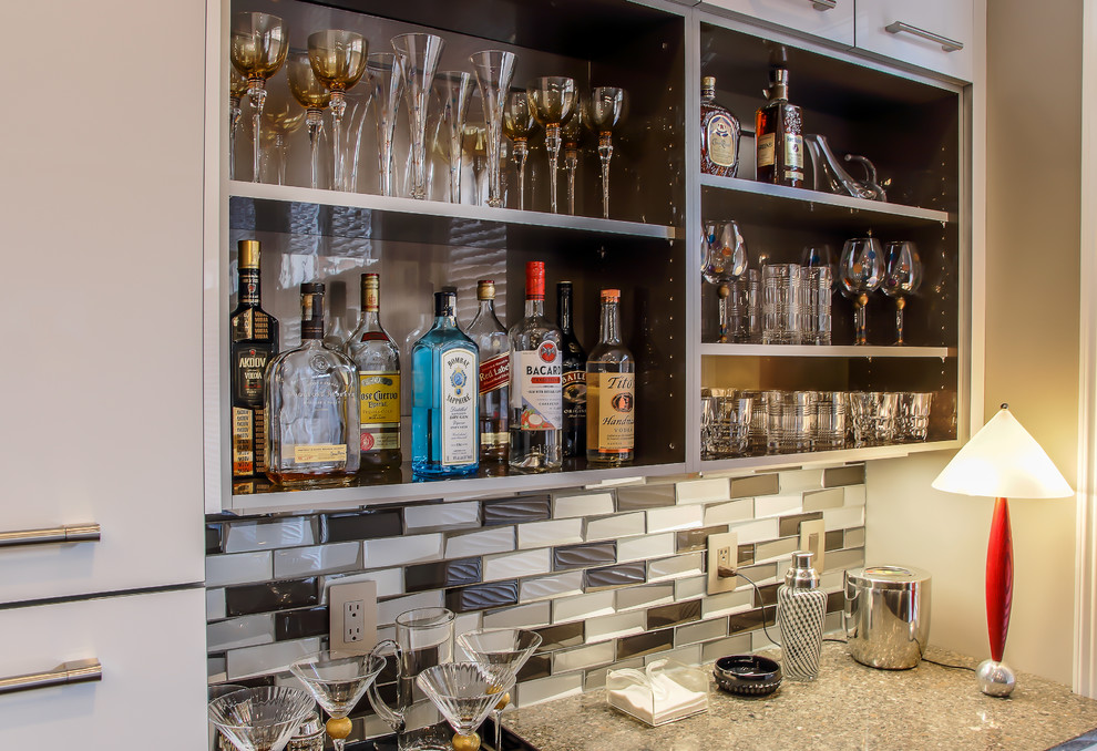 This is an example of a medium sized contemporary single-wall wet bar in Other with flat-panel cabinets, grey cabinets, grey splashback, no sink, dark hardwood flooring and brown floors.
