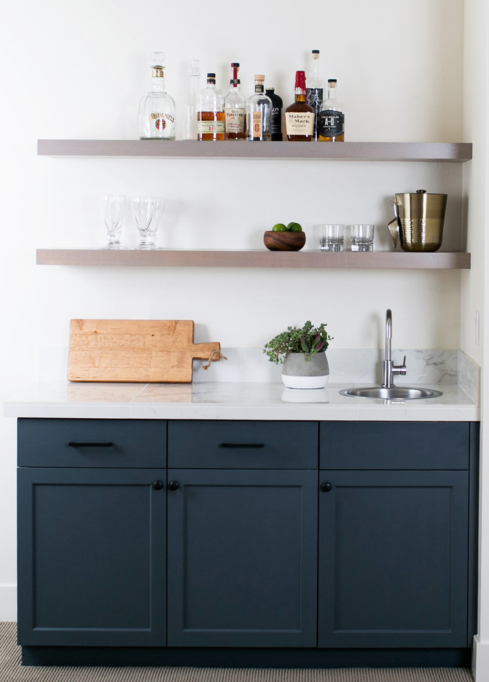 Inspiration for a small farmhouse single-wall wet bar in Portland with shaker cabinets, blue cabinets and marble worktops.
