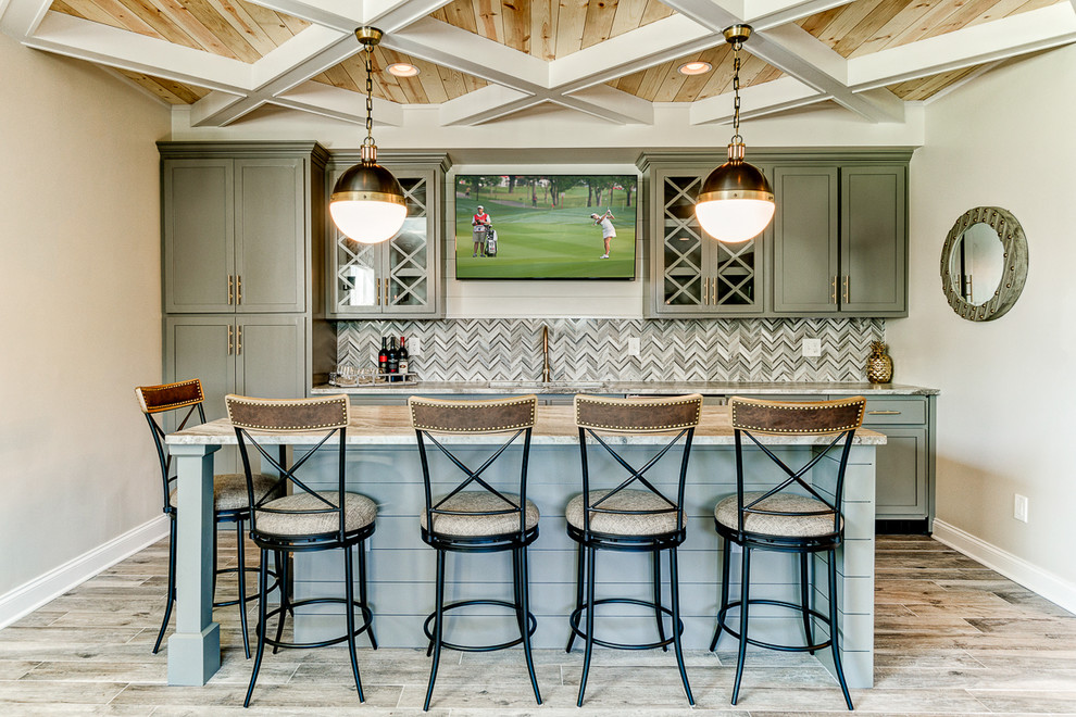 Elegant seated home bar photo in Columbus with shaker cabinets and multicolored backsplash