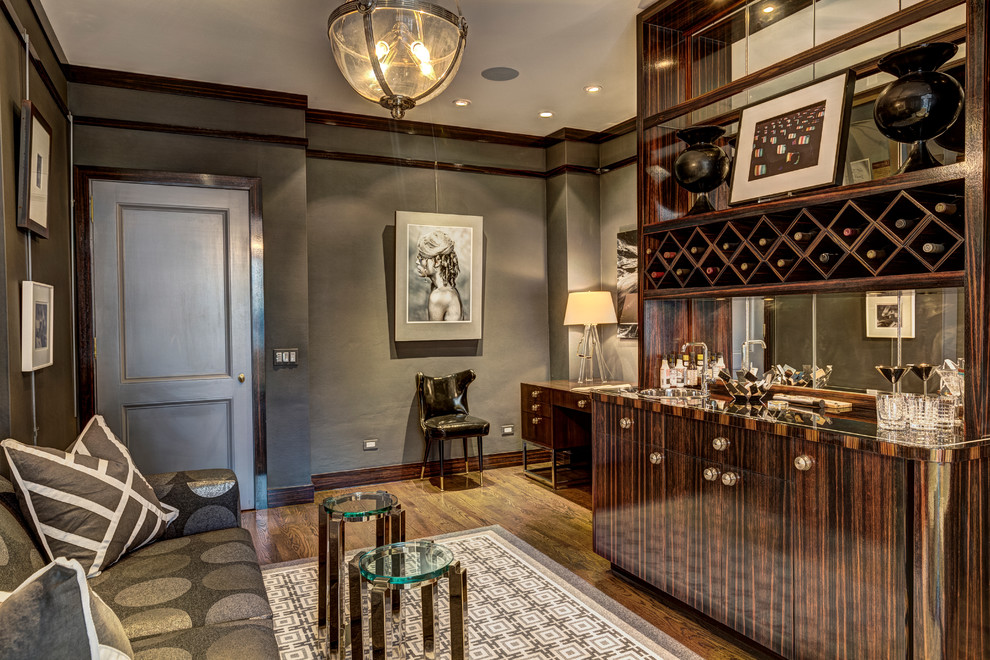 This is an example of a small contemporary single-wall wet bar in Chicago with a built-in sink, flat-panel cabinets, dark wood cabinets, medium hardwood flooring and brown floors.