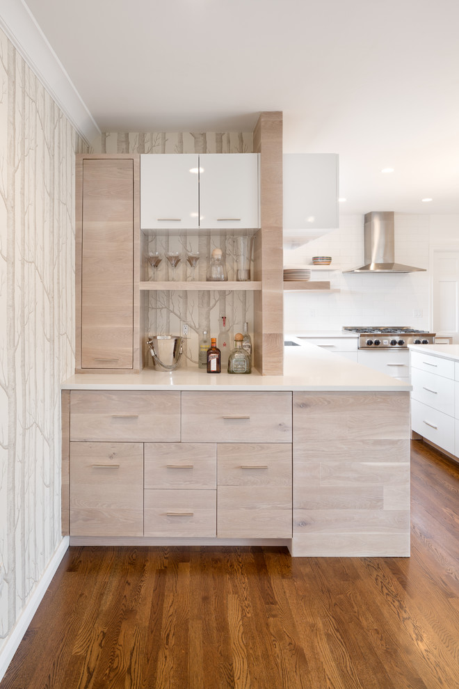 This is an example of a small contemporary home bar in Portland with light wood cabinets and white worktops.
