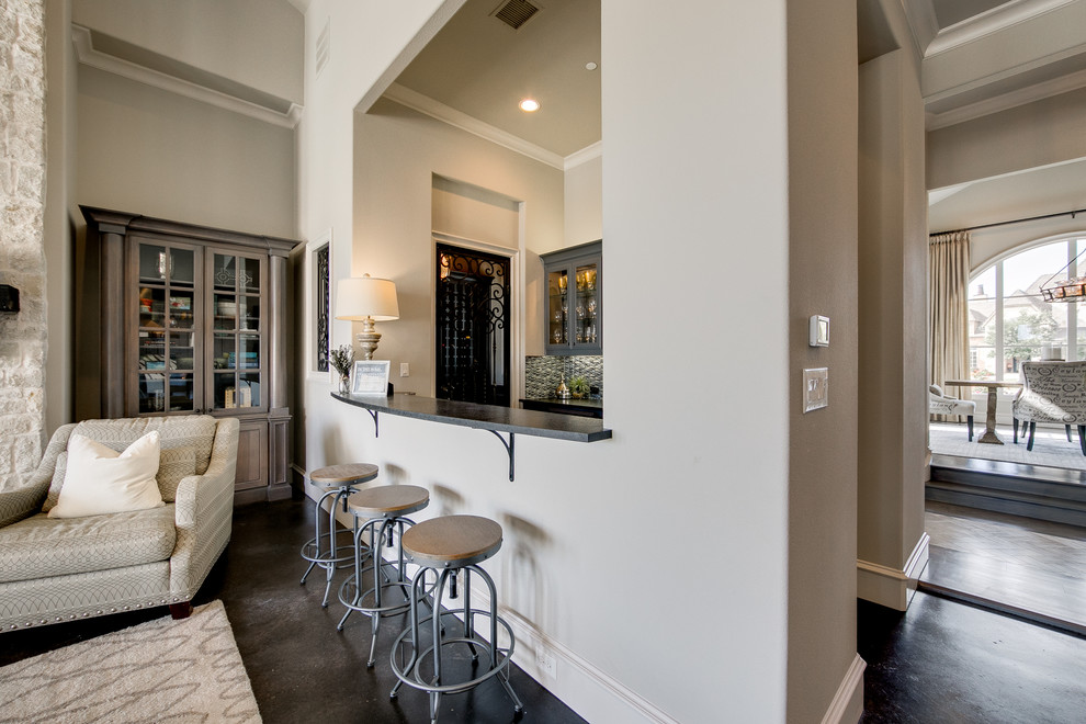 Mid-sized transitional galley concrete floor seated home bar photo in Dallas with glass-front cabinets, gray cabinets, multicolored backsplash and mosaic tile backsplash