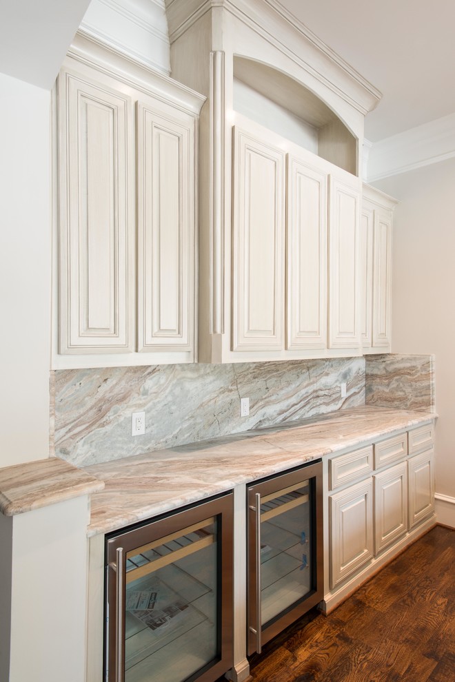 Elegant home bar photo in Dallas with marble countertops