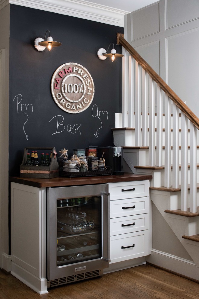 Inspiration for a small cottage single-wall dark wood floor and brown floor home bar remodel in Atlanta with shaker cabinets, white cabinets, no sink, wood countertops and brown countertops