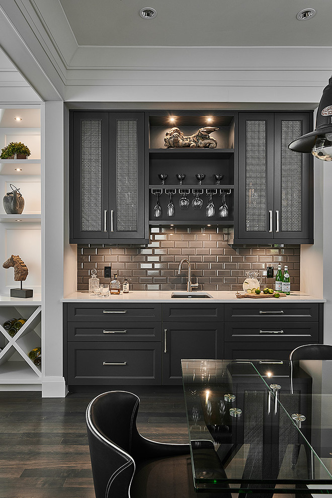 Design ideas for a small traditional single-wall wet bar in Other with a submerged sink, shaker cabinets, black cabinets, grey splashback, metro tiled splashback, dark hardwood flooring, brown floors, white worktops and engineered stone countertops.