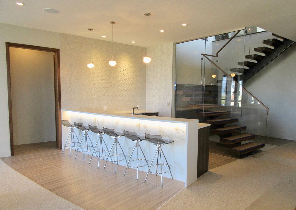 Photo of a large modern l-shaped wet bar in San Francisco with a submerged sink, engineered stone countertops, white splashback, porcelain splashback, porcelain flooring, grey floors and white worktops.