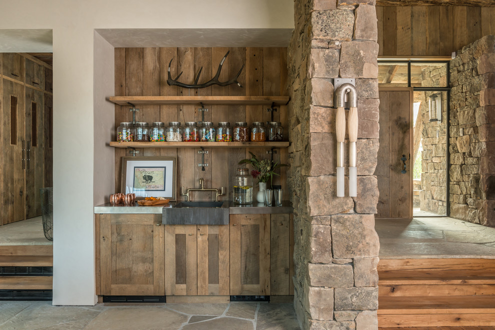Small rustic single-wall wet bar in Other with a built-in sink, shaker cabinets, medium wood cabinets, brown splashback, wood splashback and brown floors.