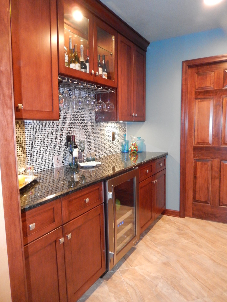 Example of a mid-sized trendy galley ceramic tile and gray floor wet bar design in Other with an undermount sink, shaker cabinets, medium tone wood cabinets, quartzite countertops and mosaic tile backsplash