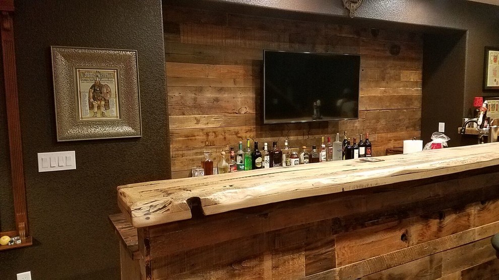 Seated home bar - large rustic l-shaped laminate floor and brown floor seated home bar idea in Denver with an undermount sink, recessed-panel cabinets, dark wood cabinets, wood countertops, brown backsplash and wood backsplash