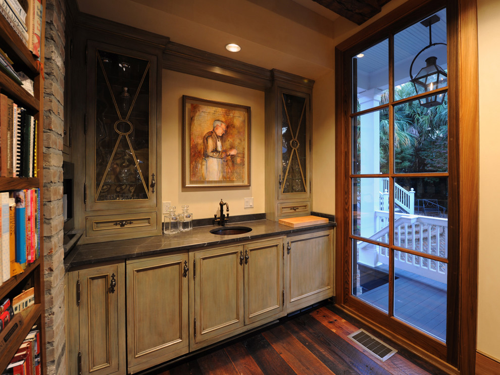 Inspiration for a small timeless dark wood floor and brown floor home bar remodel in New Orleans