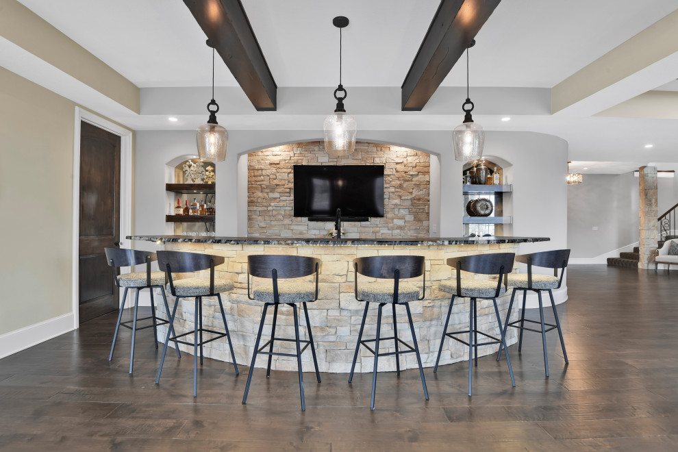 Seated home bar - large transitional galley medium tone wood floor and brown floor seated home bar idea in Kansas City with brown backsplash, stone tile backsplash and black countertops
